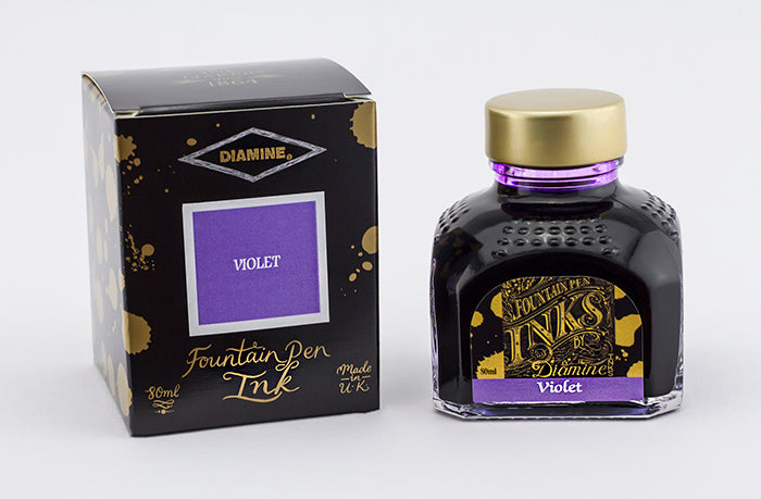 A glass bottle of 80ml Diamine Violet fountain pen ink next to its packaging box, in front of a white background.