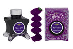 A glass bottle of 50ml Diamine Purple Edition Inkvent Raise A Glass chameleon fountain pen ink next to colour swatch and its packaging box, in front of a white background.