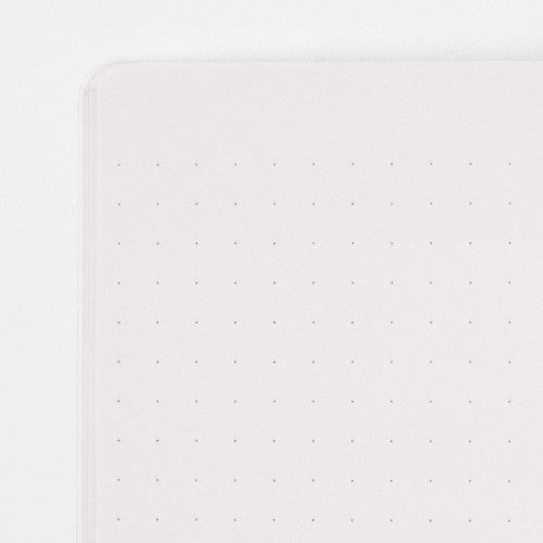 Single Midori A5 purple notebook with colour dot grid pages on a plain background.