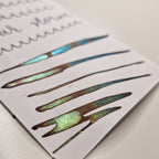 A colour swatch of Diamine Solar Storm chameleon fountain pen ink.