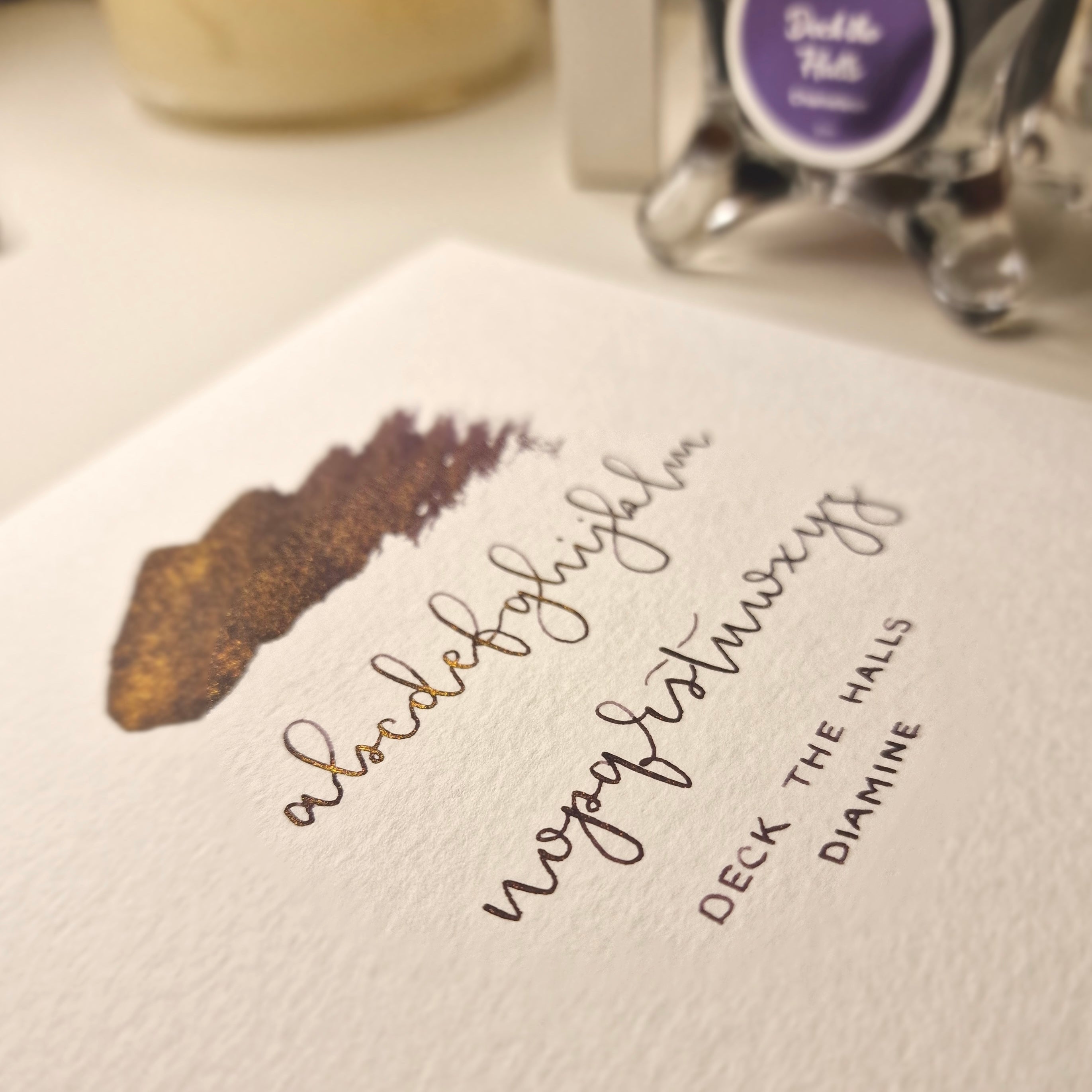 A colour writing swatch of Diamine Deck the Halls chameleon fountain pen ink.
