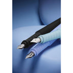 Trio of Faber‑Castell Poly Fountain Pens in black, purple and blue on a plain  blue background.