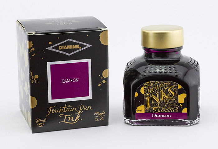 A glass bottle of 80ml Diamine Damson fountain pen ink next to its packaging box, in front of a white background.