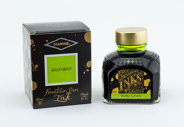 A glass bottle of 80ml Diamine Kelly Green fountain pen ink next to its packaging box, in front of a white background.