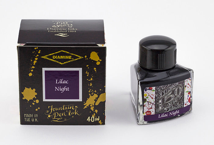 A glass bottle of 40ml Diamine 150th Anniversary Lilac Night fountain pen ink next to packaging box, in front of a white background.