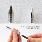 MD Fountain pen nib close up on a white background, front and side profile. Bottom of image shows hand inserting fountain pen ink cartridge.