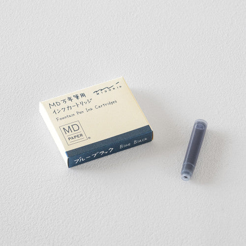 Pack of MD Midori Fountain Pen Ink Cartridges next to an individual European standard size fountain pen ink cartridge, against a white background.