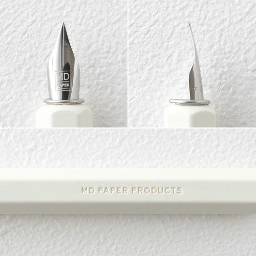 MD Dip Pen close up at nib and embossing on the side "MD PAPER PRODUCTS", against a white background.