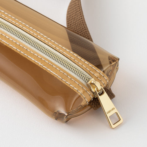 Close up of zip on Midori Book Band Pen Case in clear brown colourway on a white background.