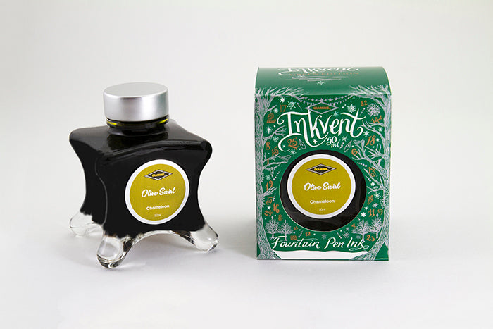 A glass bottle of 50ml Diamine Green Edition Inkvent Olive Swirl chameleon fountain pen ink next to packaging box, in front of a white background.