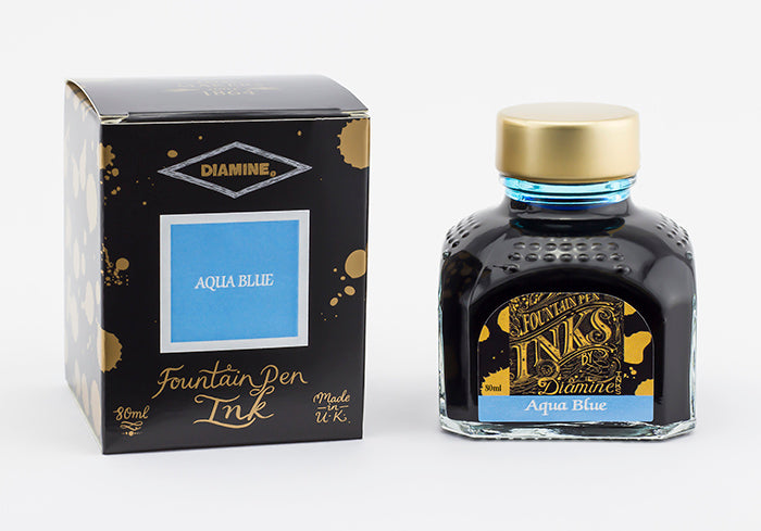 A glass bottle of 80ml Diamine Aqua Blue fountain pen ink next to its packaging box, in front of a white background.