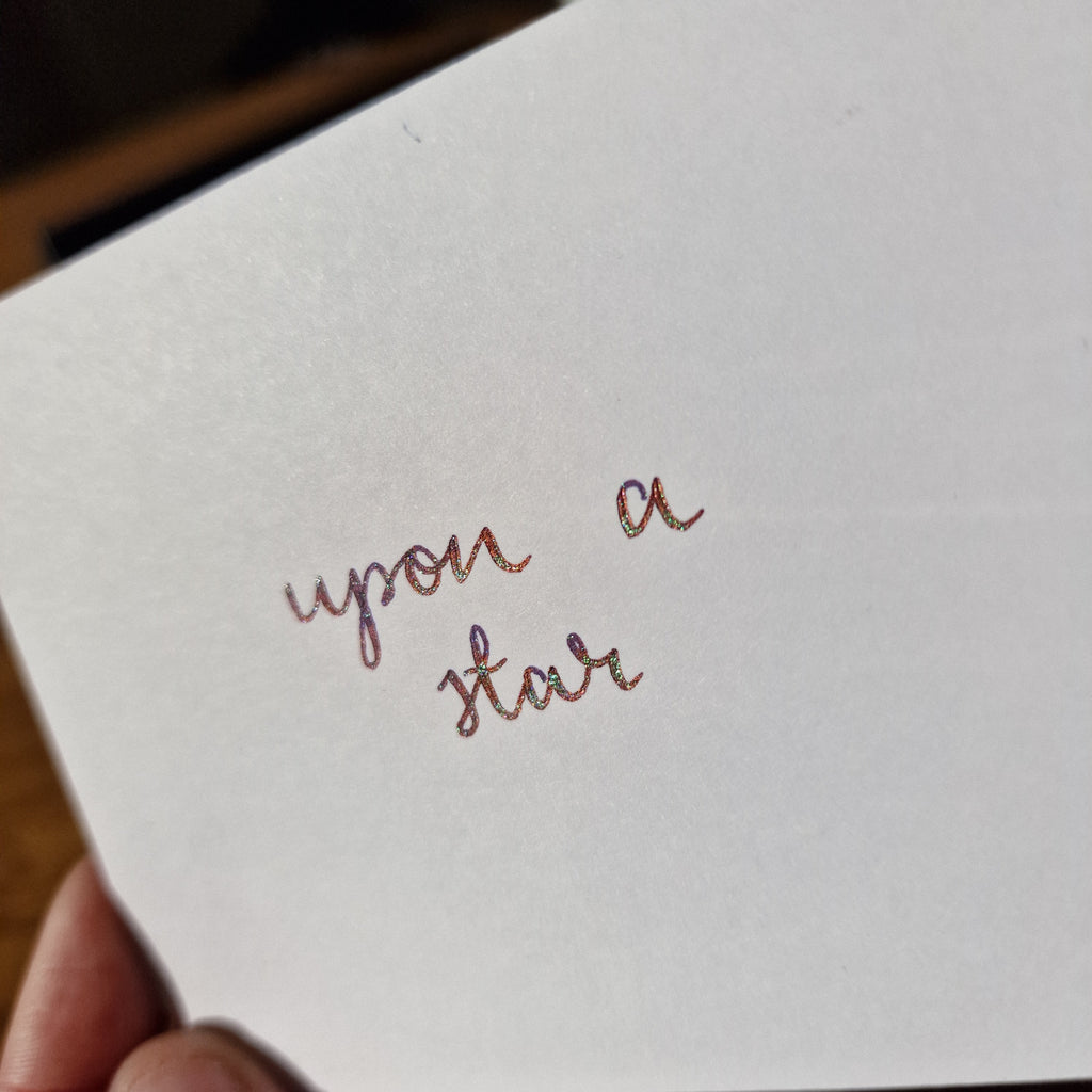 A colour swatch of Diamine Upon a Star chameleon fountain pen ink.