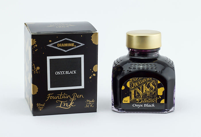 A glass bottle of 80ml Diamine Onyx Black fountain pen ink next to its packaging box, in front of a white background.