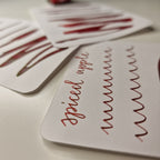 A colour writing swatch of Diamine Spiced Apple chameleon fountain pen ink.