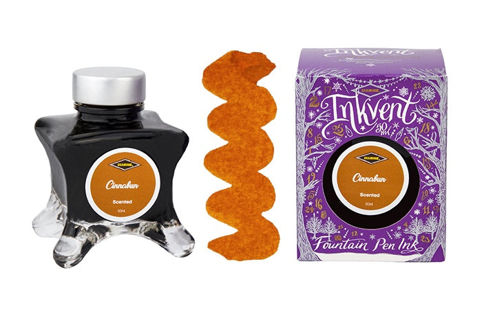 A glass bottle of 50ml Diamine Purple Edition Inkvent Cinnabun scented fountain pen ink next to colour swatch and its packaging box, in front of a white background.