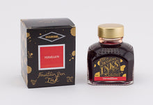 Load image into Gallery viewer, A glass bottle of 80ml Diamine Vermillion fountain pen ink next to its packaging box, in front of a white background.

