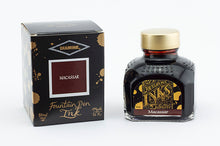 Load image into Gallery viewer, A glass bottle of 80ml Diamine Macassar fountain pen ink next to its packaging box, in front of a white background.
