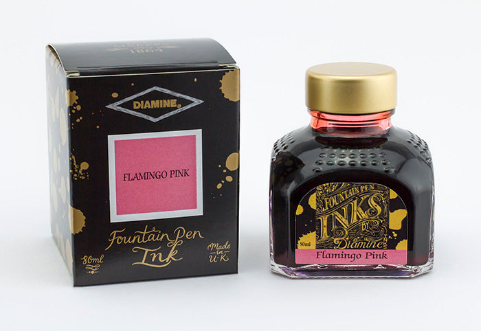 A glass bottle of 80ml Diamine Flamingo Pink fountain pen ink next to its packaging box, in front of a white background.