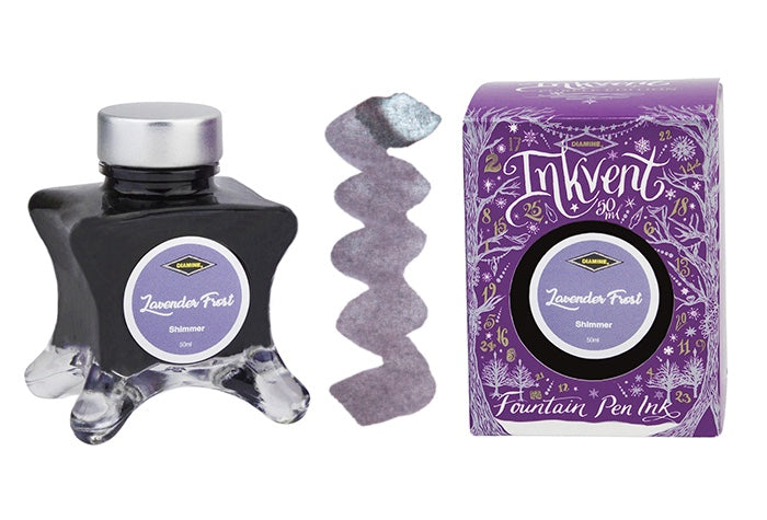 A glass bottle of 50ml Diamine Purple Edition Inkvent Lavender Frost shimmering fountain pen ink next to colour swatch and its packaging box, in front of a white background.
