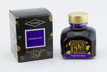 Load image into Gallery viewer, A glass bottle of 80ml Diamine Imperial Blue fountain pen ink next to its packaging box, in front of a white background.
