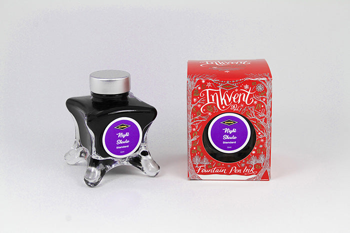 A glass bottle of 50ml Diamine Red Edition Inkvent Nightshade fountain pen ink next to packaging box, in front of a white background.