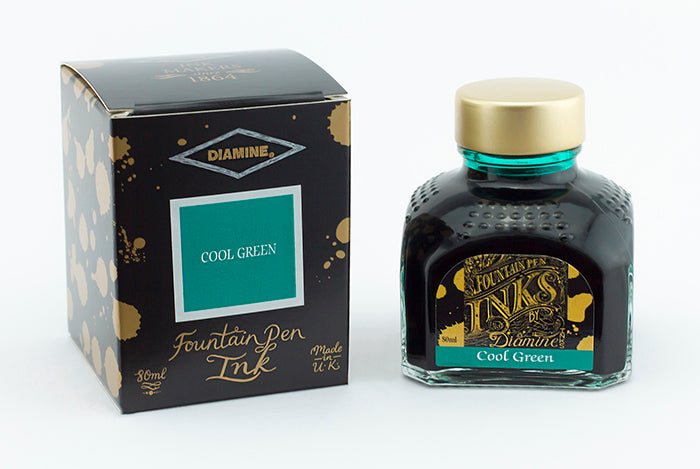A glass bottle of 80ml Diamine Cool Green fountain pen ink next to its packaging box, in front of a white background.