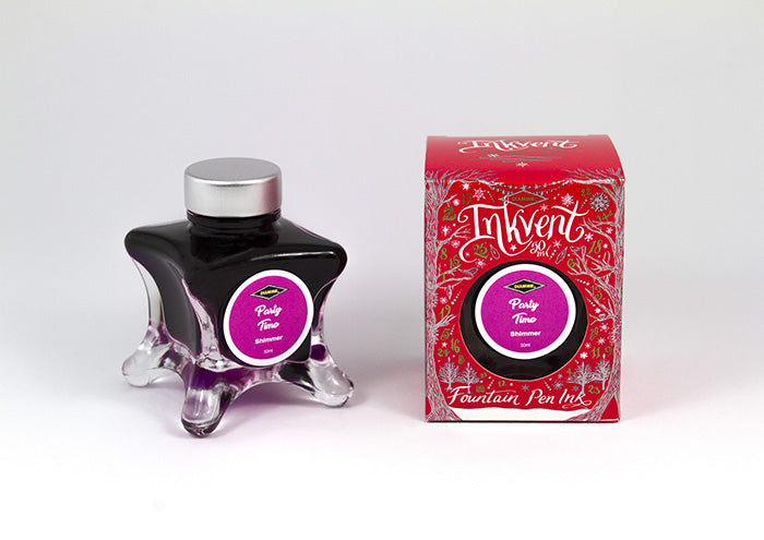 A glass bottle of 50ml Diamine Red Edition Inkvent Party Time Shimmer fountain pen ink next to packaging box, in front of a white background.