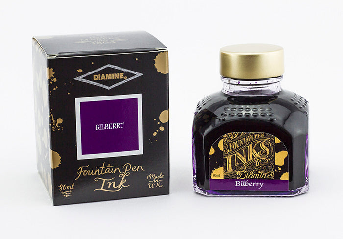 A glass bottle of 80ml Diamine Bilberry fountain pen ink next to its packaging box, in front of a white background.