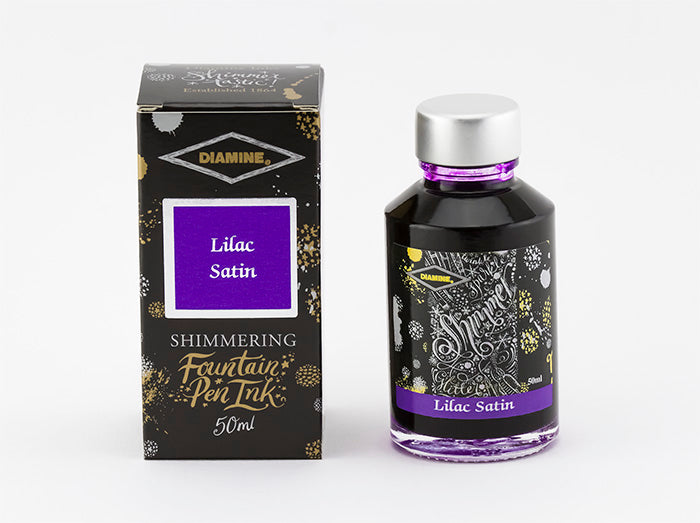 A glass bottle of 50ml Diamine Lilac Satin shimmering fountain pen ink next to its packaging box, in front of a white background.
