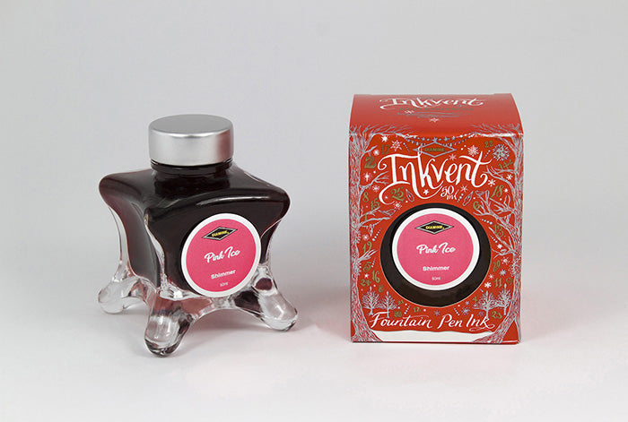 A glass bottle of 50ml Diamine Red Edition Inkvent Pink Ice Shimmer fountain pen ink next to packaging box, in front of a white background.
