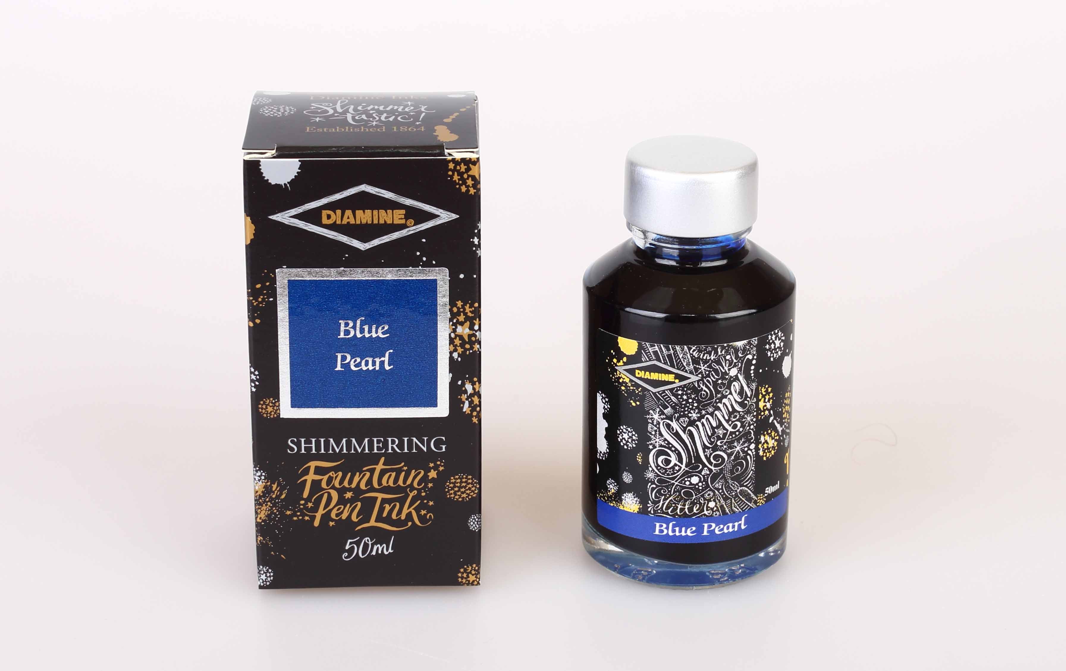 A glass bottle of 50ml Diamine Blue Pearl shimmering fountain pen ink next to its packaging box, in front of a white background.