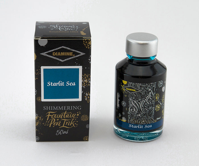 A glass bottle of 50ml Diamine Starlit Sea shimmering fountain pen ink next to its packaging box, in front of a white background.
