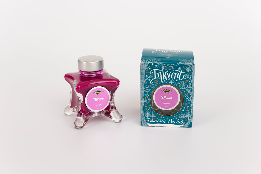 Glass bottle of 50ml Diamine Teal Edition Inkvent Mittens pigment fountain pen ink next to Teal coloured and Christmas-themed packaging box, in front of a white background.