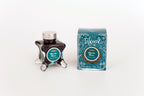 Glass bottle of 50ml Diamine Teal Edition Inkvent Myrrh the Merrier fountain pen ink next to Teal coloured and Christmas-themed packaging box, in front of a white background.
