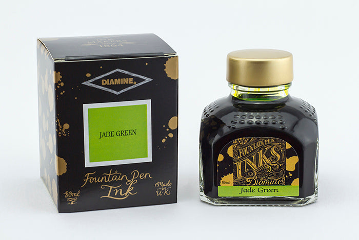 A glass bottle of 80ml Diamine Jade Green fountain pen ink next to its packaging box, in front of a white background.