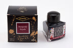 A glass bottle of 40ml Diamine 150th Anniversary Burgundy Royale fountain pen ink next to packaging box, in front of a white background.