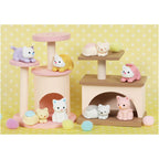 A group of pastel‑coloured Iwako cat erasers arranged on a miniature replica cat tree, each perched on different platforms like playful kittens.