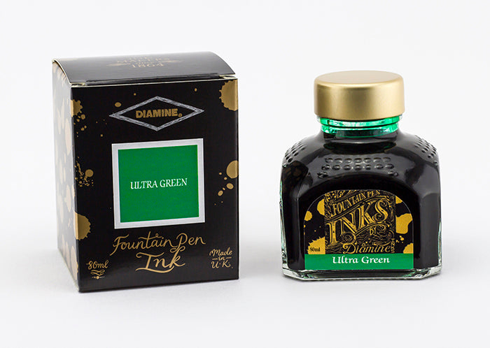 A glass bottle of 80ml Diamine Ultra Green fountain pen ink next to its packaging box, in front of a white background.