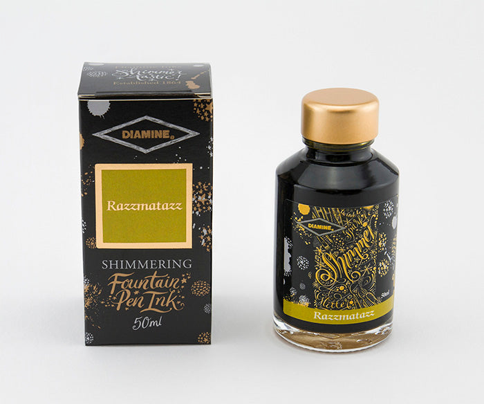 A glass bottle of 50ml Diamine Razzmatazz shimmering fountain pen ink next to its packaging box, in front of a white background.