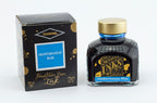 A glass bottle of 80ml Diamine Mediterranean Blue fountain pen ink next to its packaging box, in front of a white background.