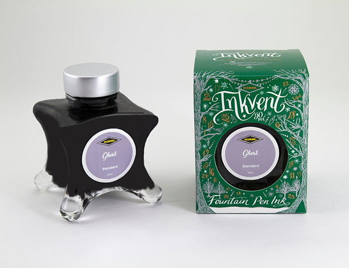 A glass bottle of 50ml Diamine Green Edition Inkvent Ghost fountain pen ink next to packaging box, in front of a white background.