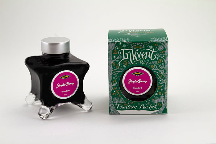 A glass bottle of 50ml Diamine Green Edition Inkvent Jingle Berry fountain pen ink next to packaging box, in front of a white background.