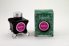 A glass bottle of 50ml Diamine Green Edition Inkvent Jingle Berry fountain pen ink next to packaging box, in front of a white background.