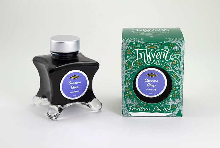 A glass bottle of 50ml Diamine Green Edition Inkvent One More Sleep fountain pen ink next to packaging box, in front of a white background.