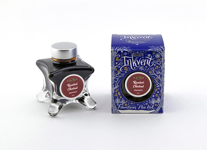 A glass bottle of 50ml Diamine Blue Edition Inkvent Roasted Chestnut fountain pen ink next to packaging box, in front of a white background.