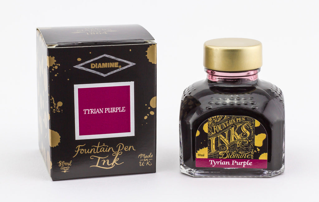 A glass bottle of 80ml Diamine Tyrian Purple fountain pen ink next to its packaging box, in front of a white background.