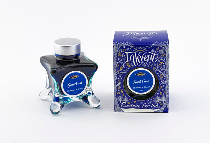 A glass bottle of 50ml Diamine Blue Edition Inkvent Jack Frost shimmer fountain pen ink next to packaging box, in front of a white background.