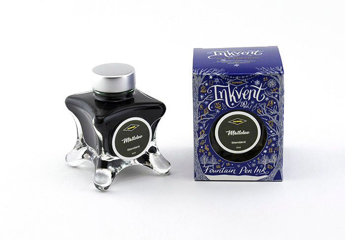 A glass bottle of 50ml Diamine Blue Edition Inkvent Mistletoe fountain pen ink next to packaging box, in front of a white background.