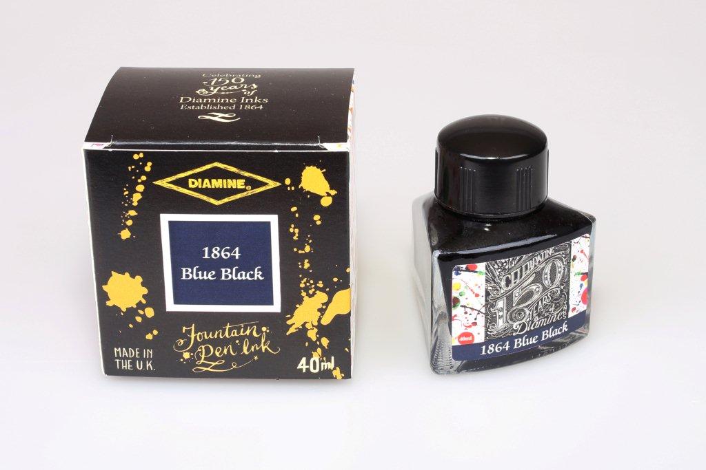 A glass bottle of 40ml Diamine 150th Anniversary 1864 Blue Black fountain pen ink next to packaging box, in front of a white background.
