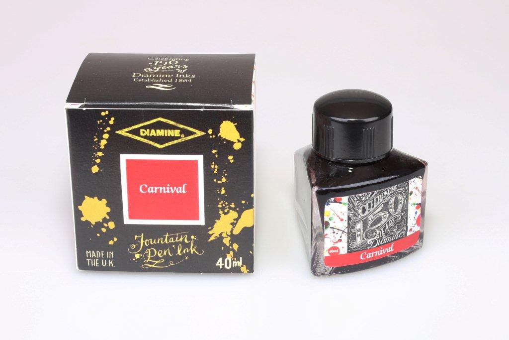 A glass bottle of 40ml Diamine 150th Anniversary Carnival fountain pen ink next to packaging box, in front of a white background.